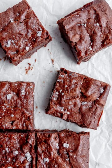 Vegan brownies on white parchment paper.