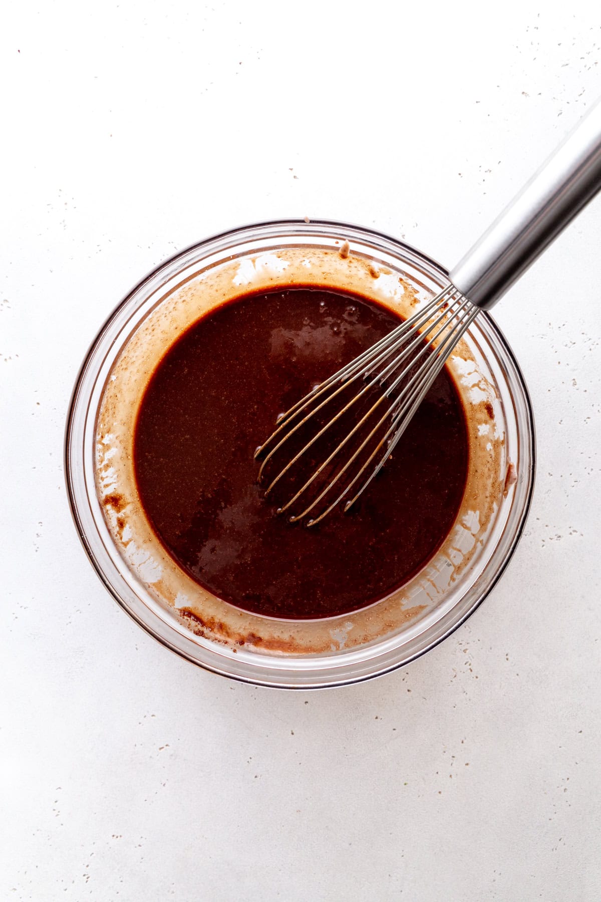 Melted chocolate in a glass bowl.