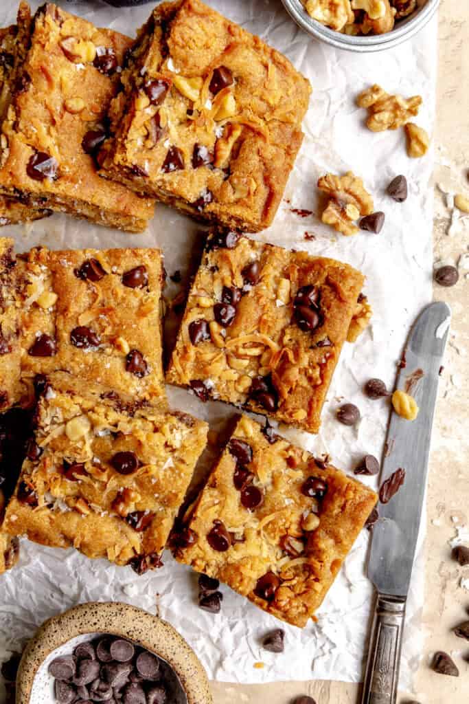 Blondie squares and scattered walnuts and chocolate chips.