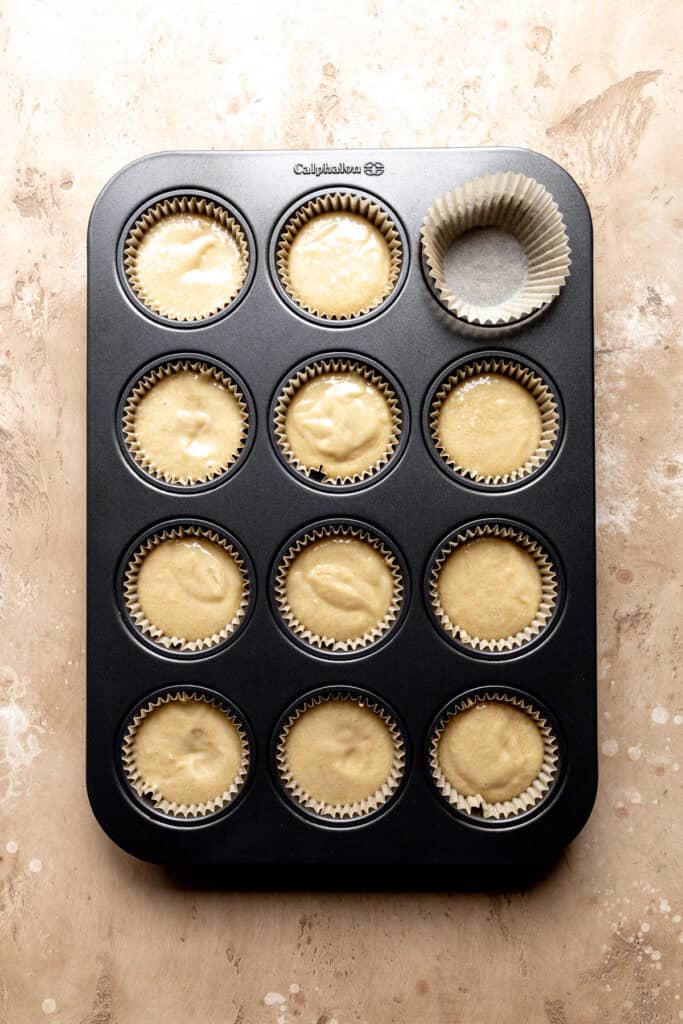 Unbaked vanilla cupcakes in a cupcake pan.