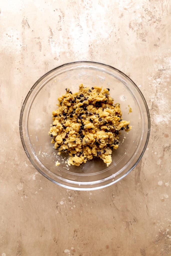 Chocolate chip cookie dough in a glass bowl.