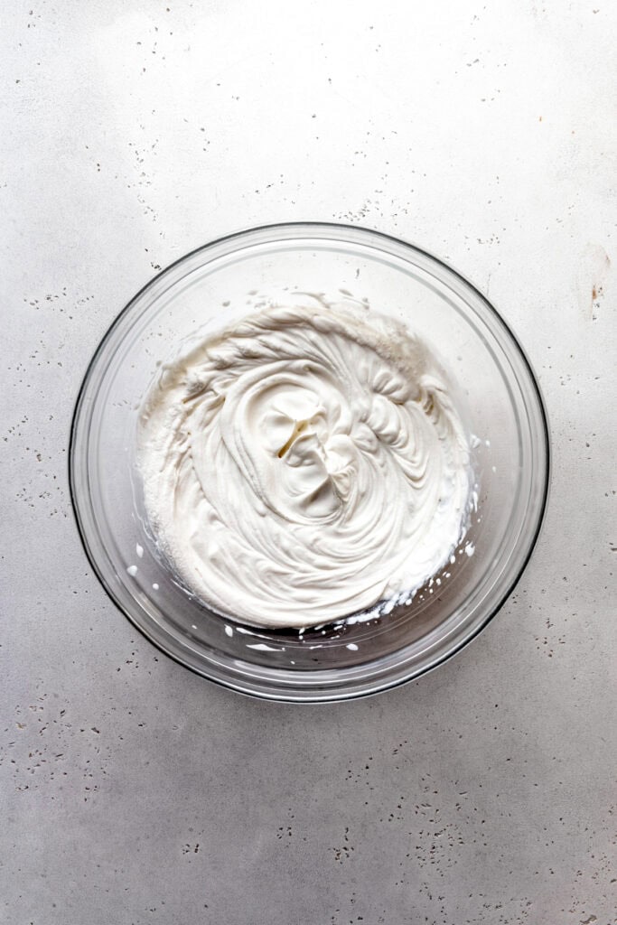 Glass bowl of whipped cream.