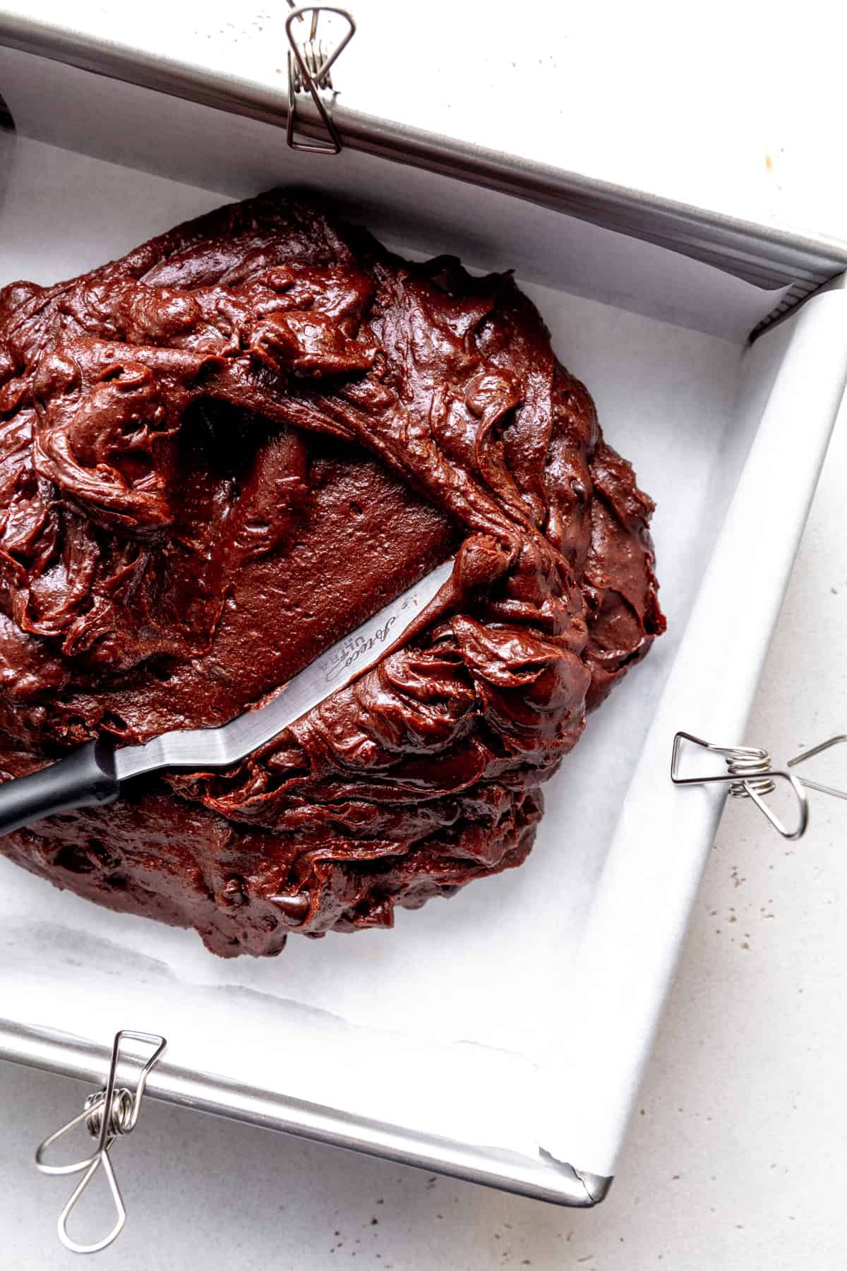 Brownie batter in a square pan.