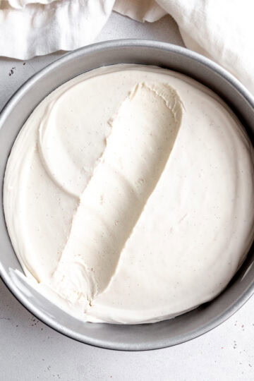 Round pan of vegan vanilla ice cream and a white linen napkin.