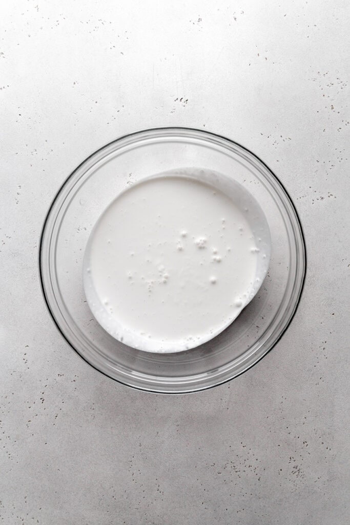 Glass bowl of dairy-free heavy cream.