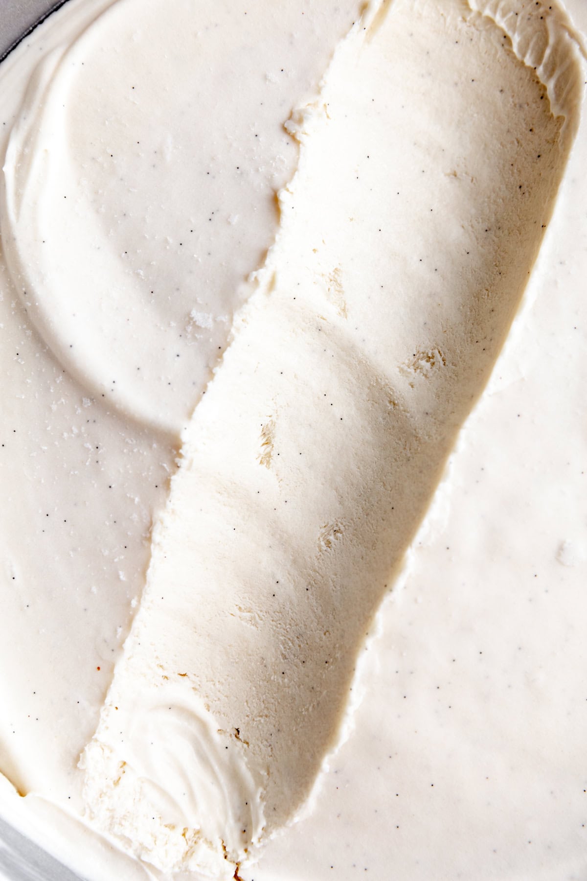 Vanilla ice cream with a scoop missing.