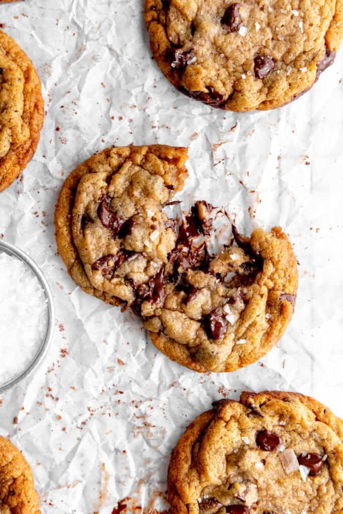 Banana chocolate chip cookie broken in half on a wire cooling rack.