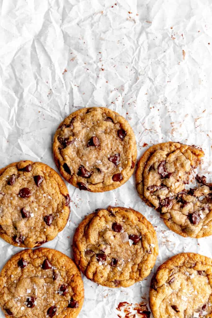 Banana chocolate chip cookies on white parchment paper.