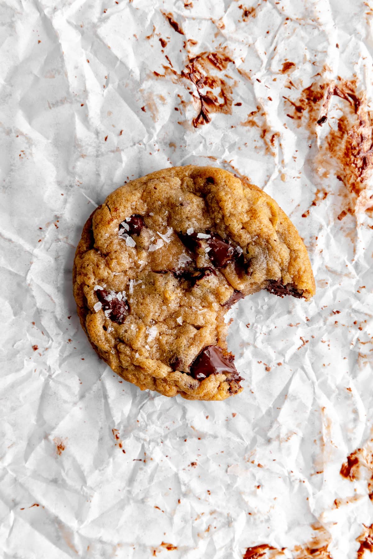 Banana chocolate chip cookie with a bite taken out of it.
