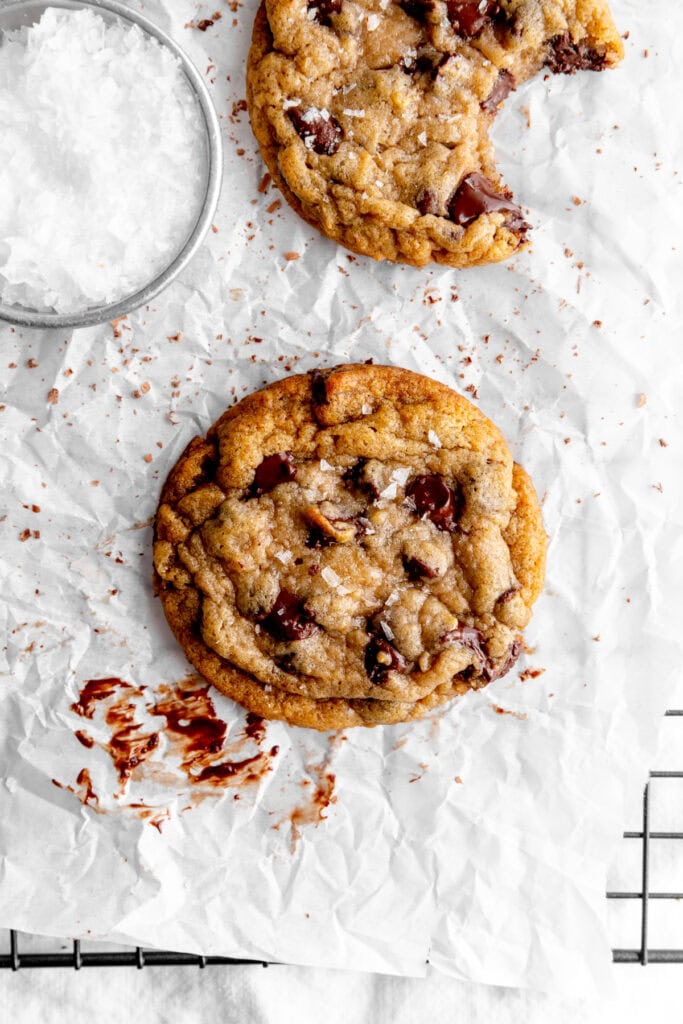Banana chocolate chip cookie on a wire rack with parchment paper.