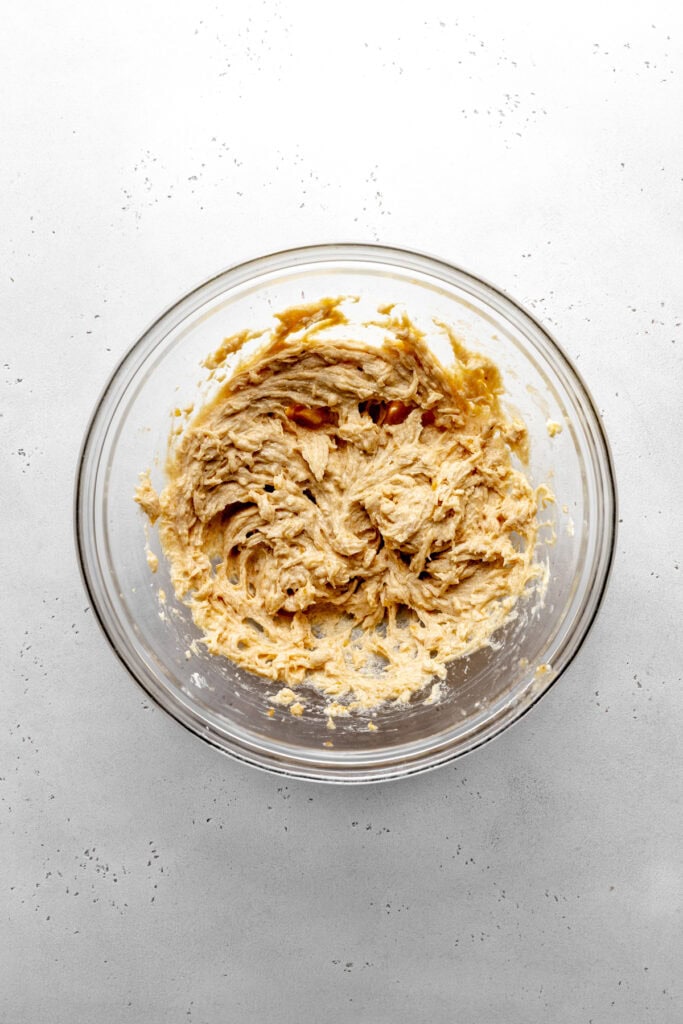 Creamed butter and sugar in a glass bowl.