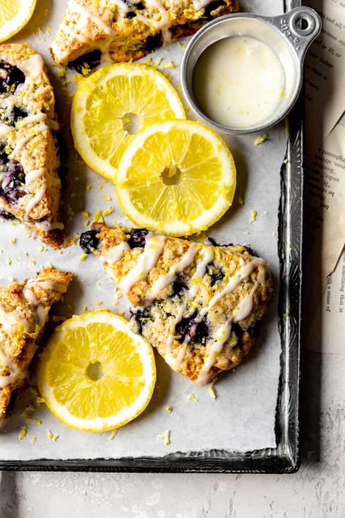 Lemon blueberry scones and a cup of glaze.