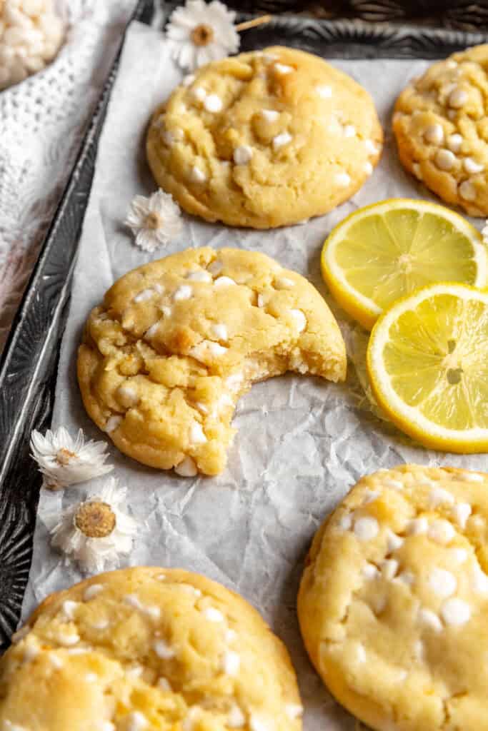 Lemon white chocolate cookie with a bite taken out of it.