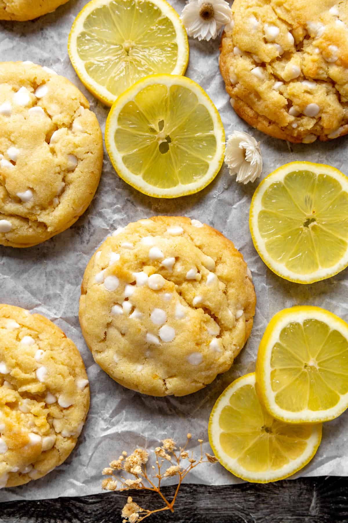 Lemon white chocolate cookies, lemon slices and flower petals.