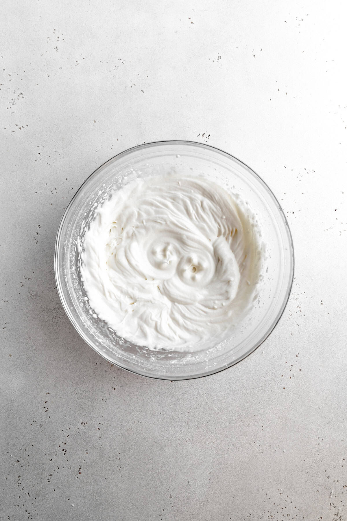 Whipped cream in a glass bowl.