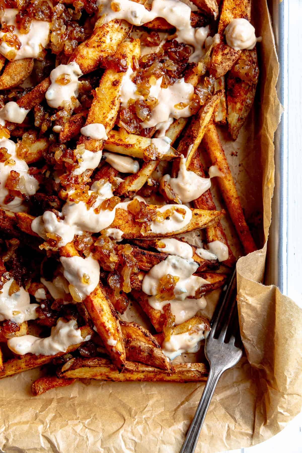 Animal fries on a baking sheet with a fork.