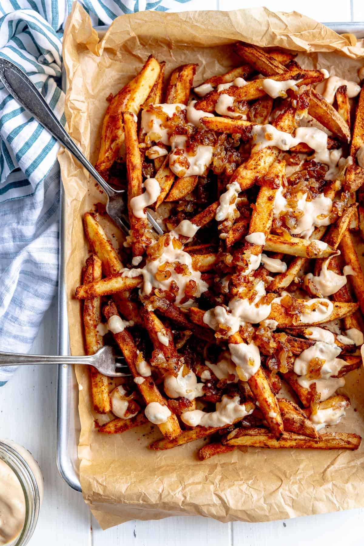 Animal fries on a baking sheet with two forks.