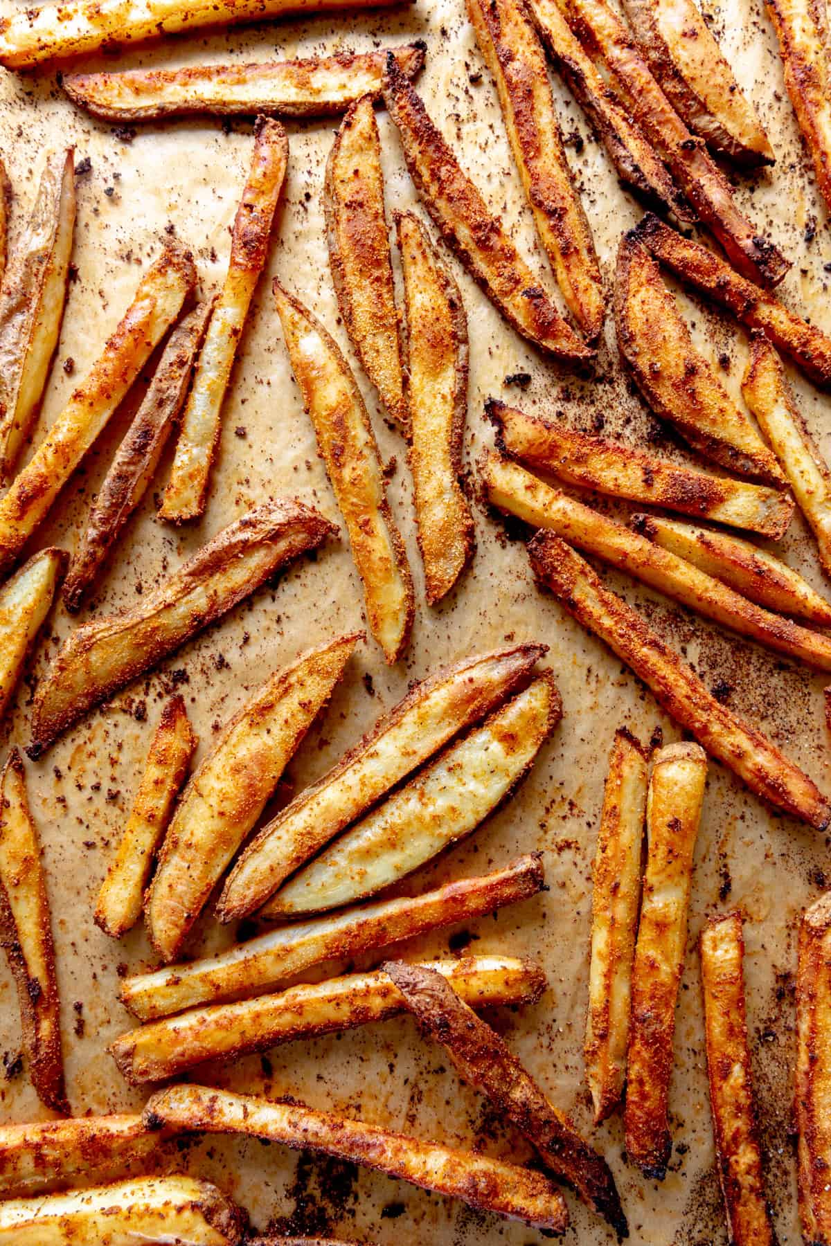 Baked french fries on a baking sheet.