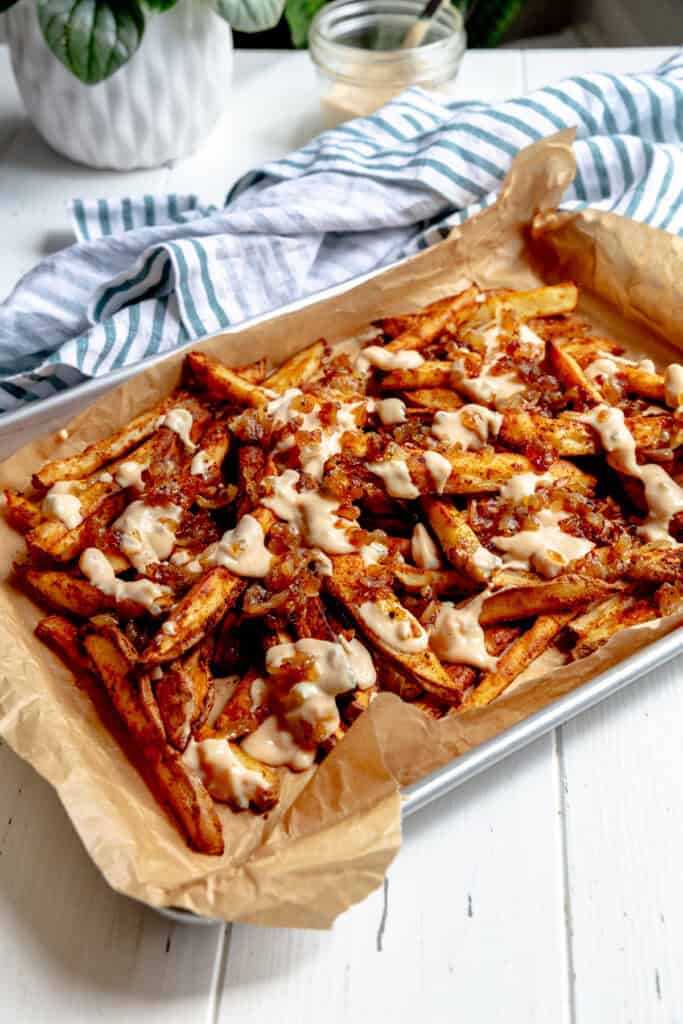 Animal fries on a baking sheet and a striped linen napkin.