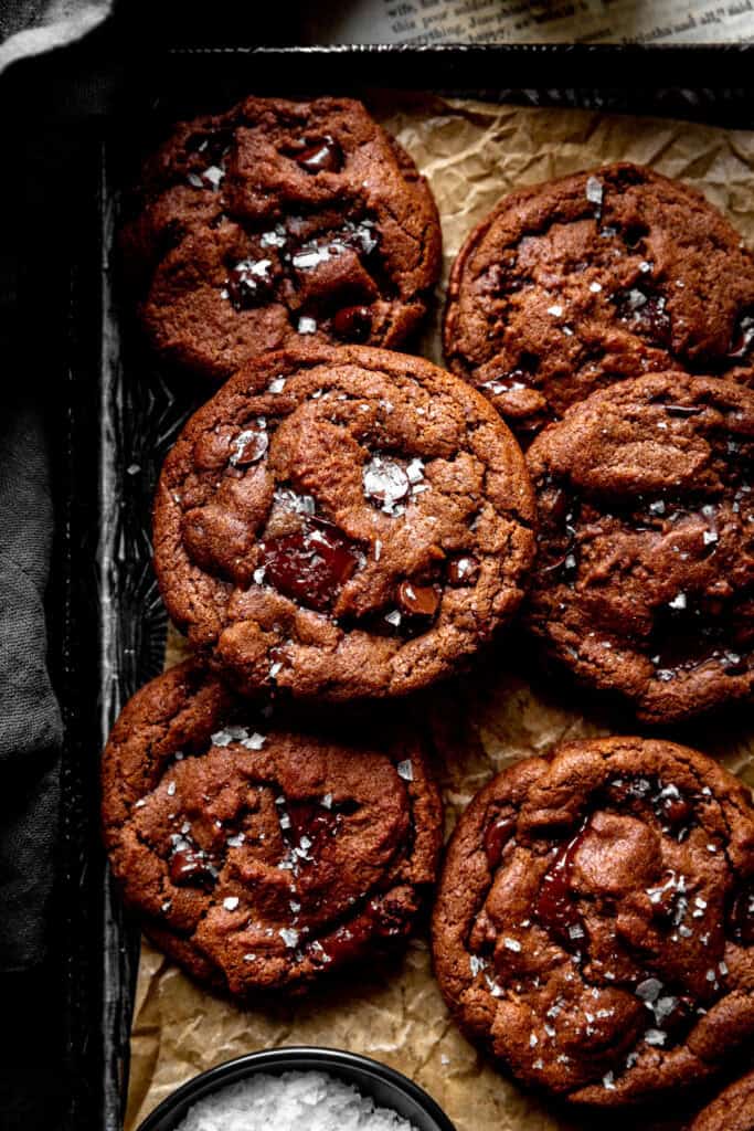 Double chocolate cookies on a baking sheet and a linen napkin.