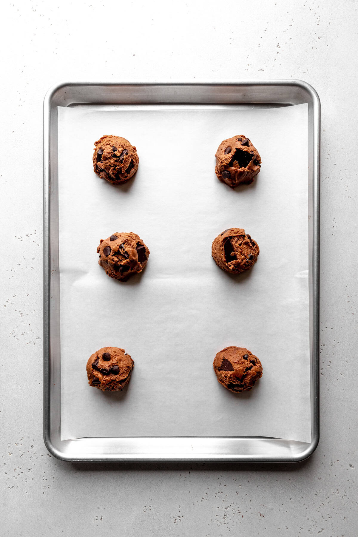 Unbaked double chocolate cookies on a baking sheet.