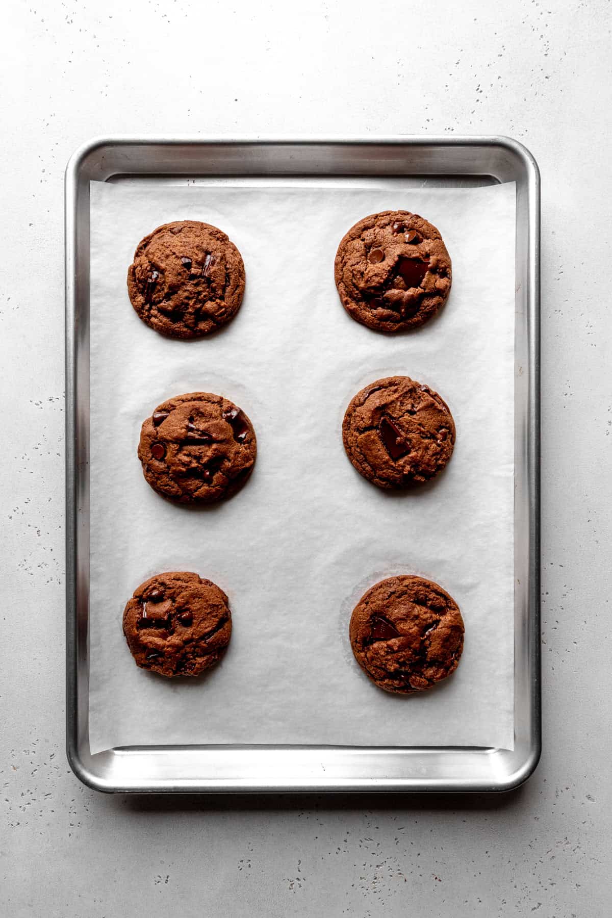 Baked chocolate cookies on a baking sheet.
