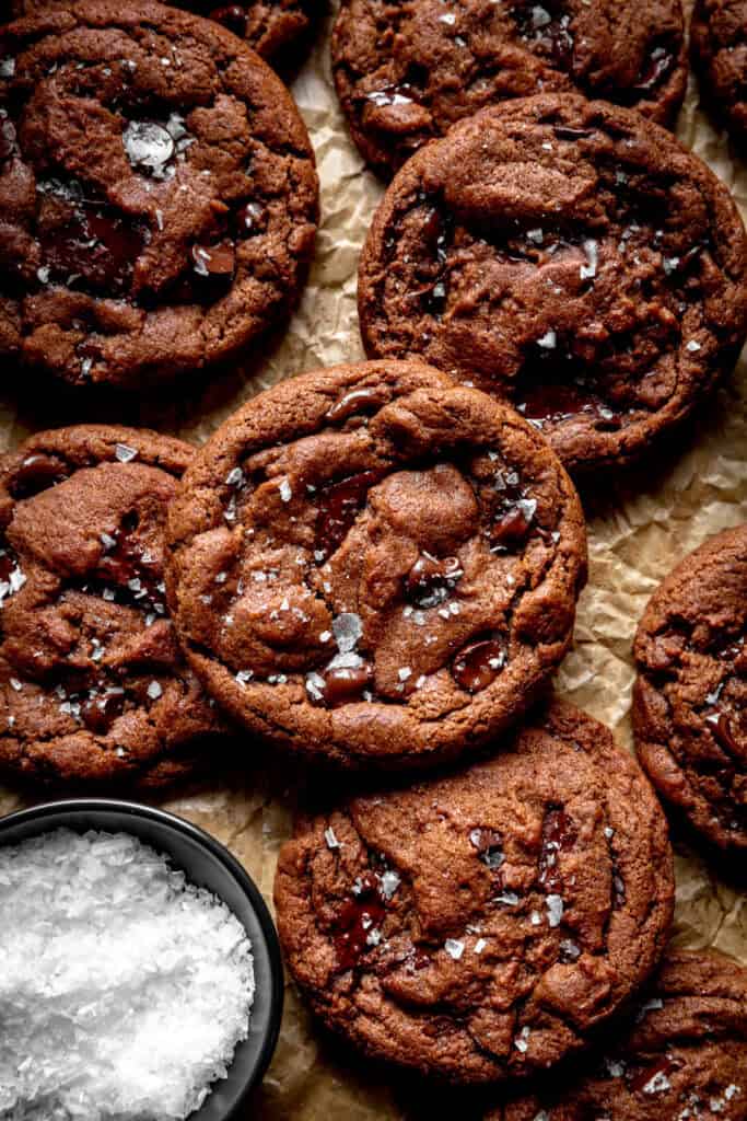 Double chocolate cookies and a small bowl of flaky salt.