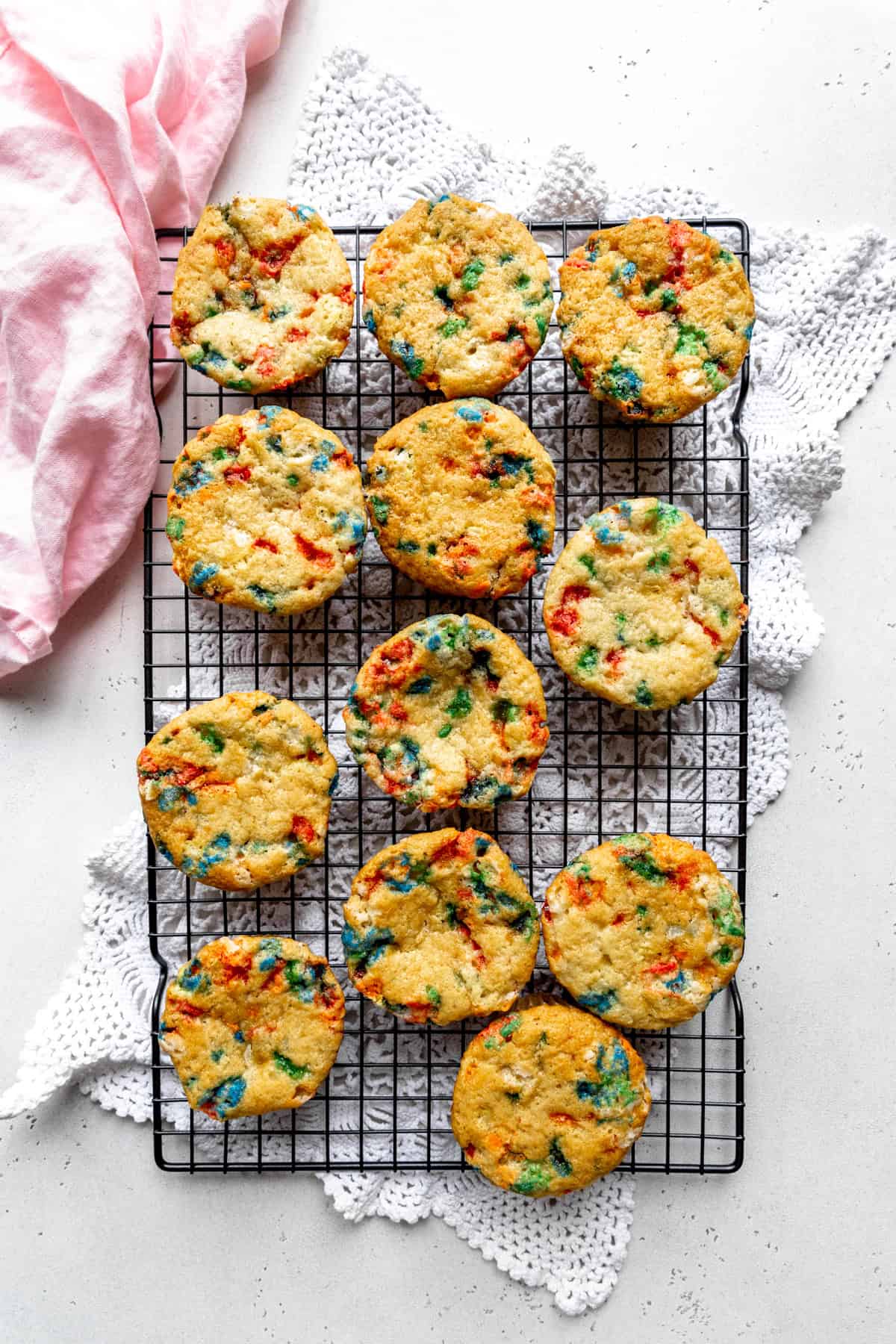 Baked funfetti cupcakes on a wire cooling rack.
