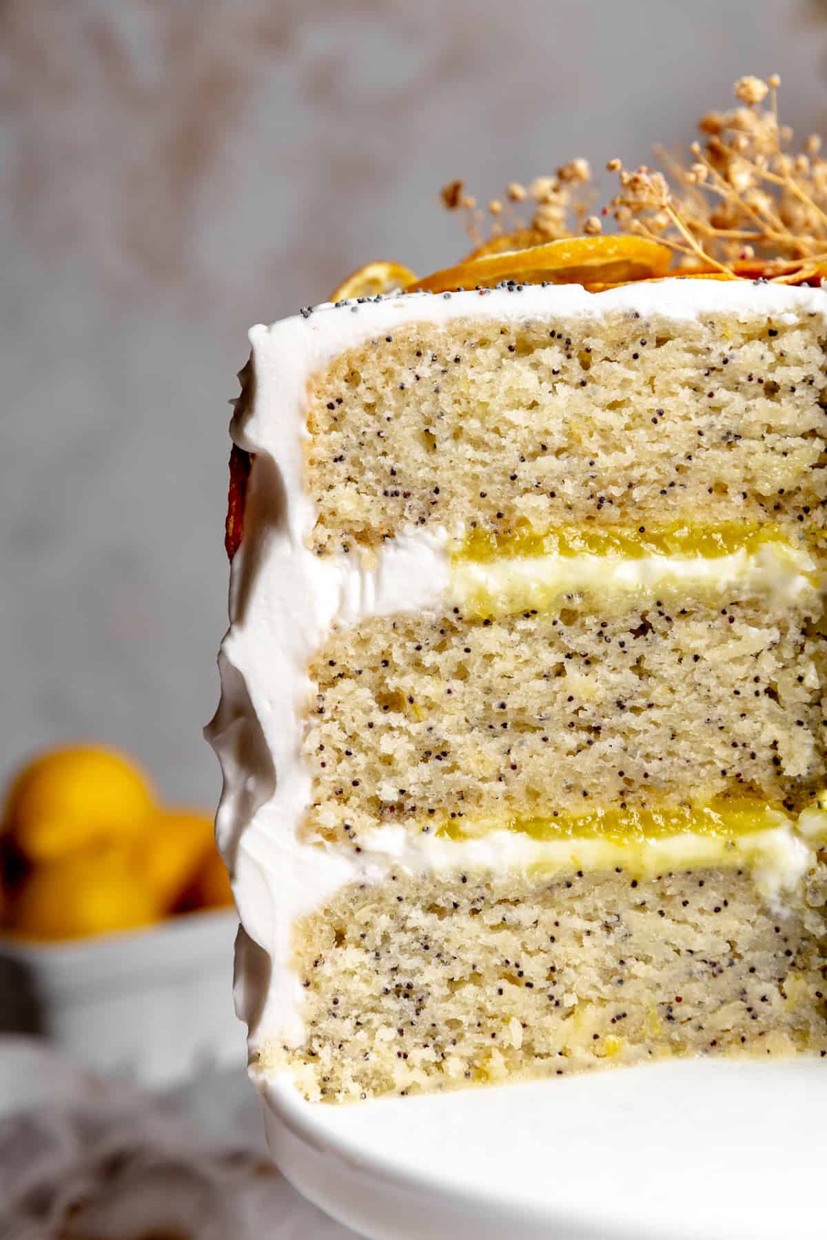 Lemon poppyseed cake layers sandwiching lemon curd and frosting.