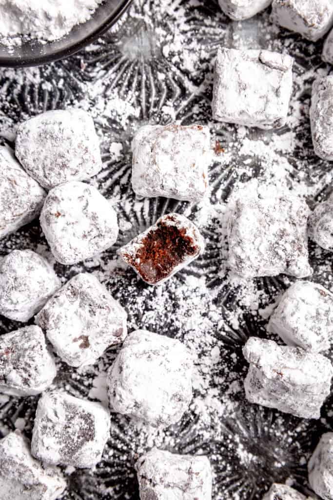 Brownie bite with a bite taken out of it.