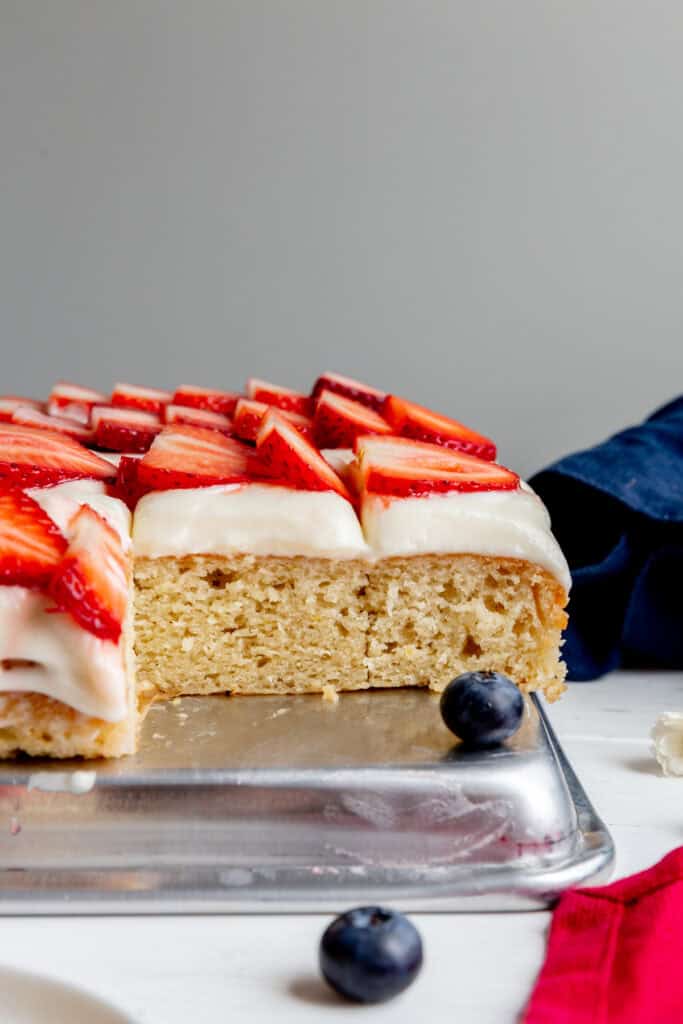 Sheet cake topped with sliced strawberries.