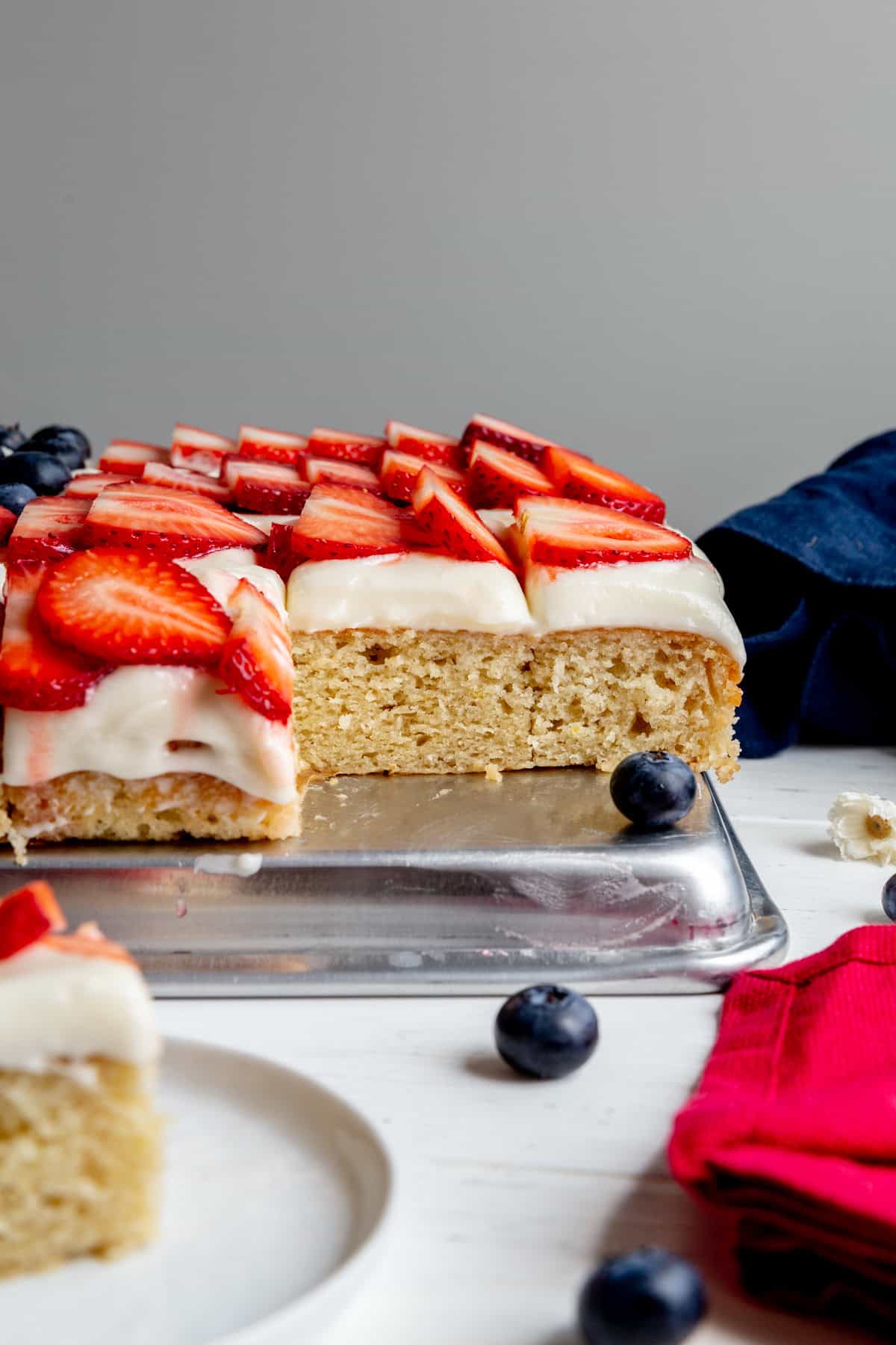 Sheet cake topped with sliced strawberries.