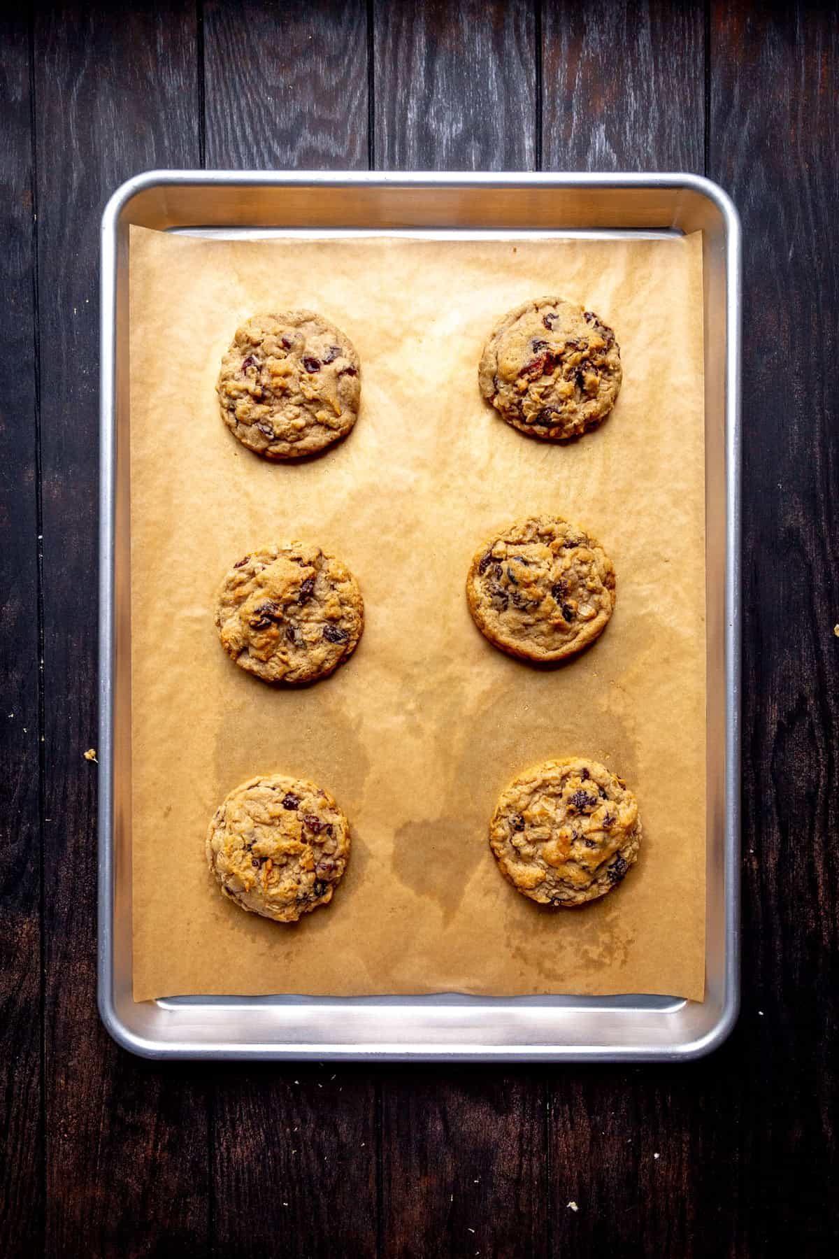 Baked oatmeal raisin cookies on a baking sheet.