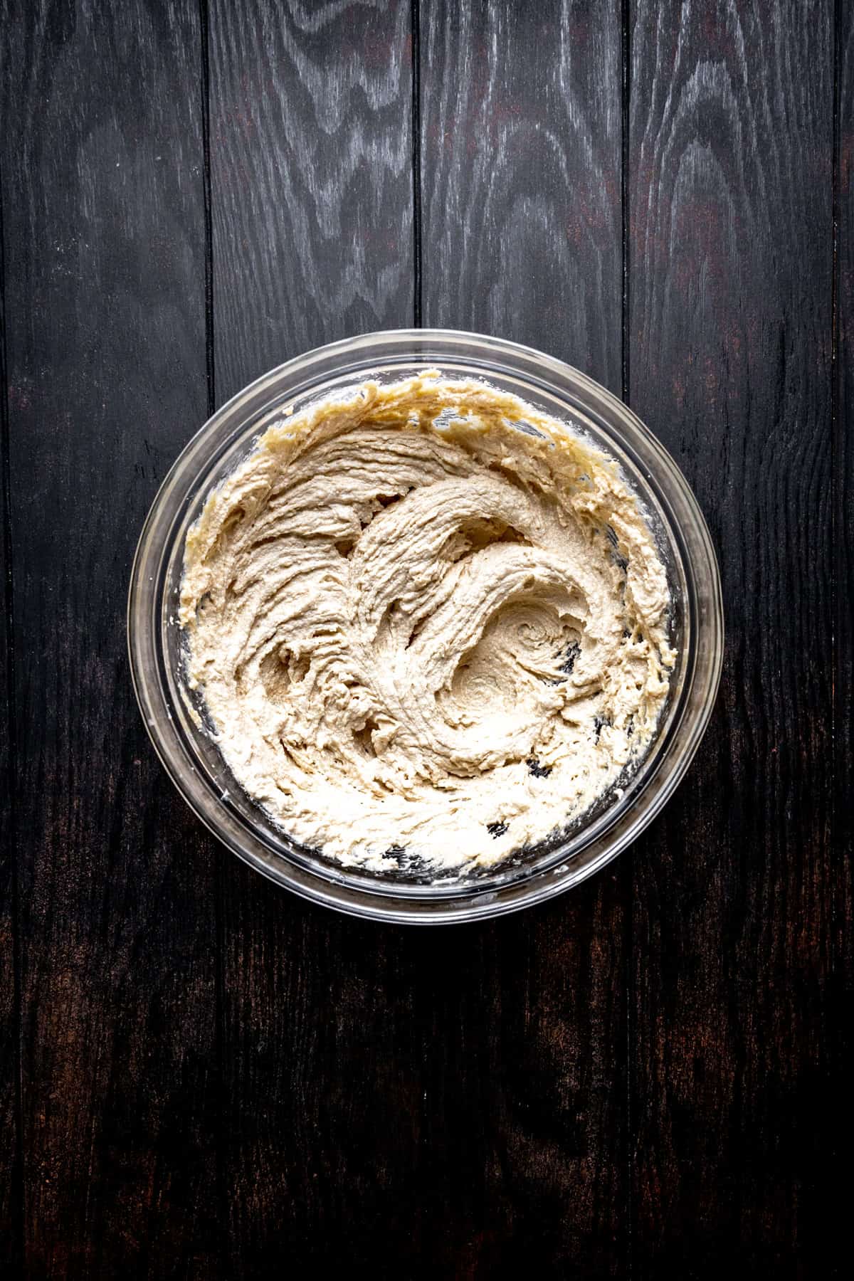 Glass bowl of creamed butter and sugar.