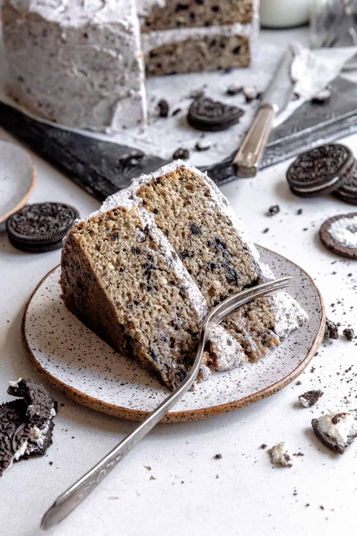 Fork cutting into a slice of oreo cake.