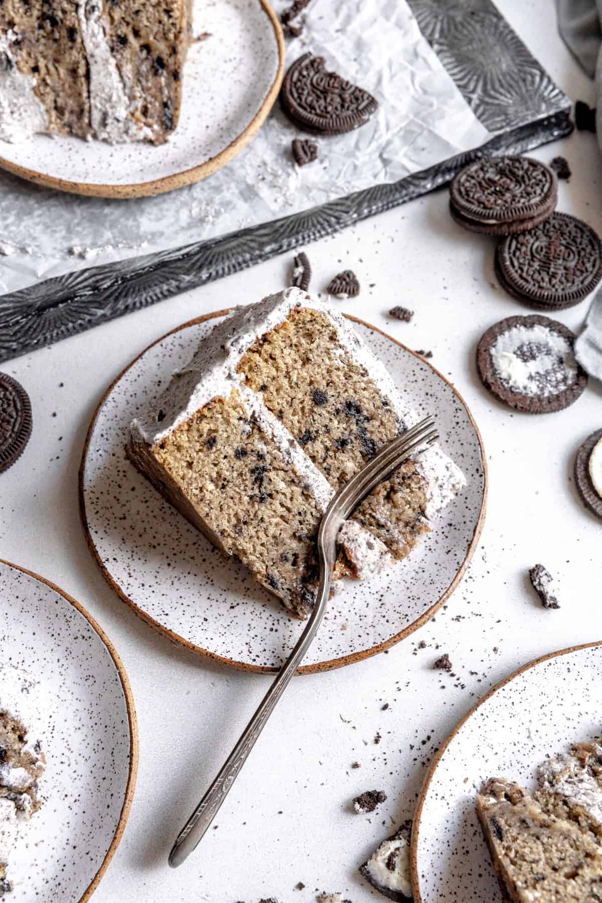 Slices of oreo cake on white plates.