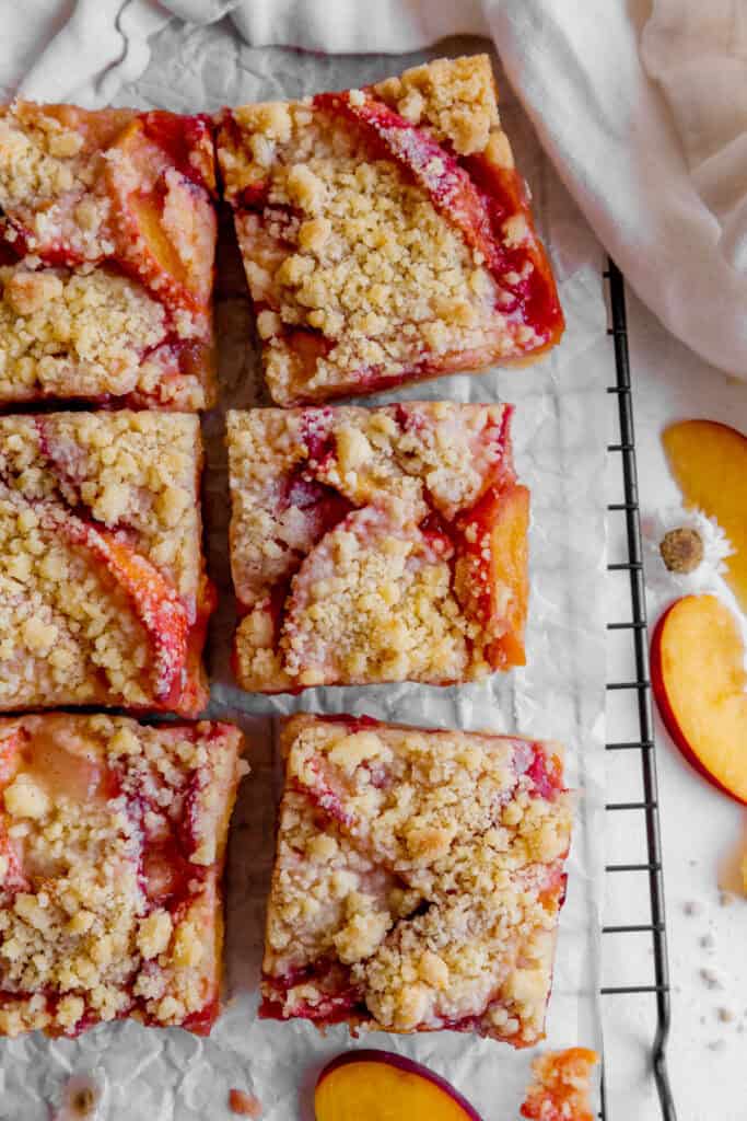 Peach crumble bars and a white linen napkin.