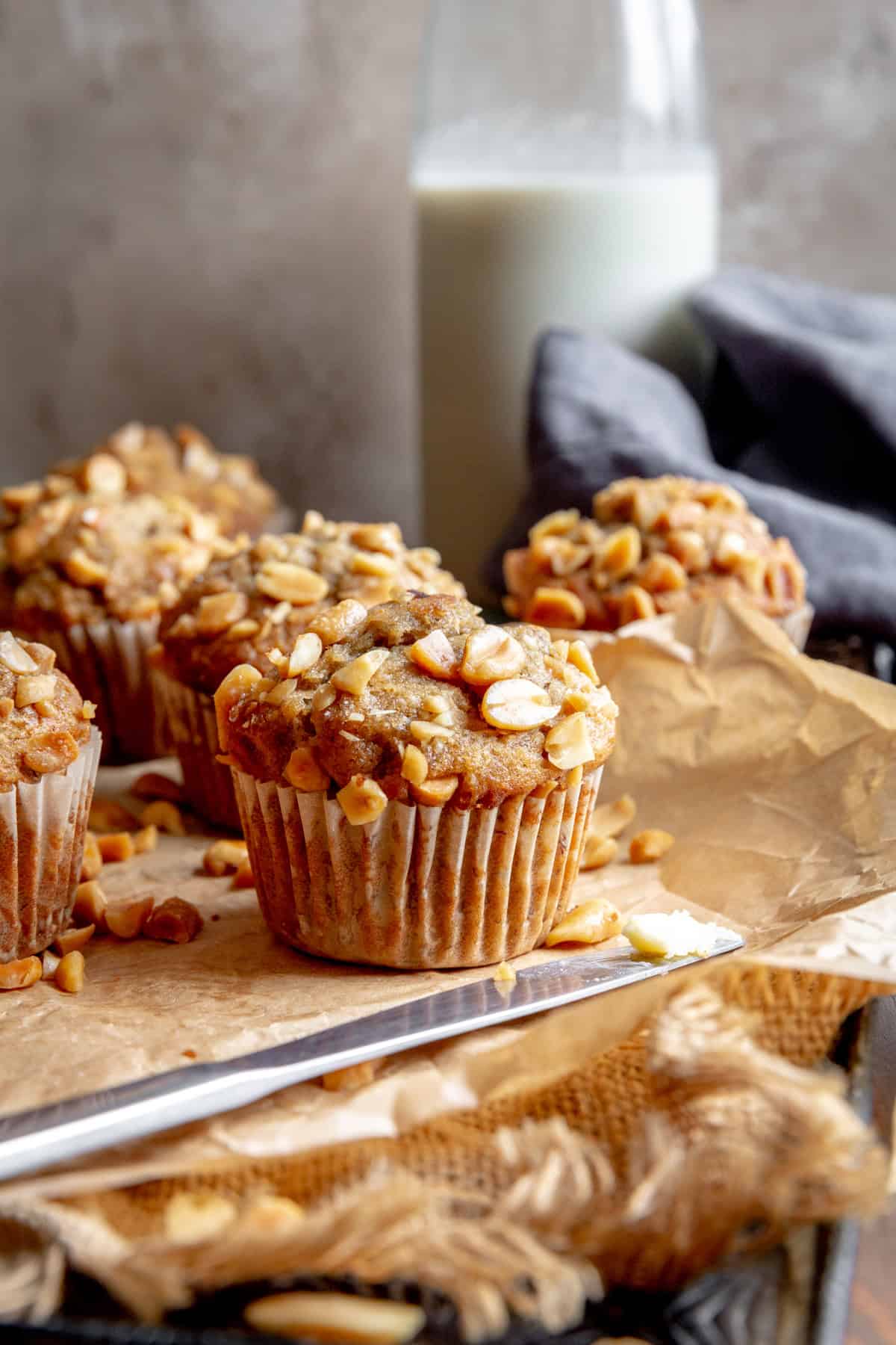 Peanut butter banana muffins, a linen napkin and a jug of milk.