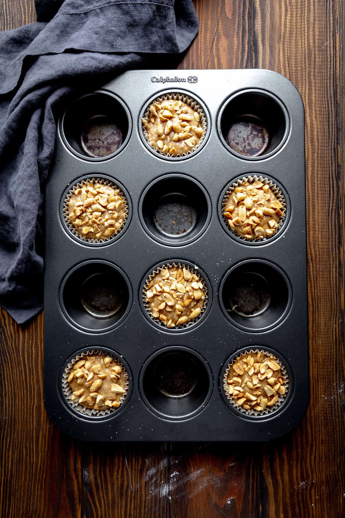 Unbaked peanut butter banana muffins in a cupcake pan.