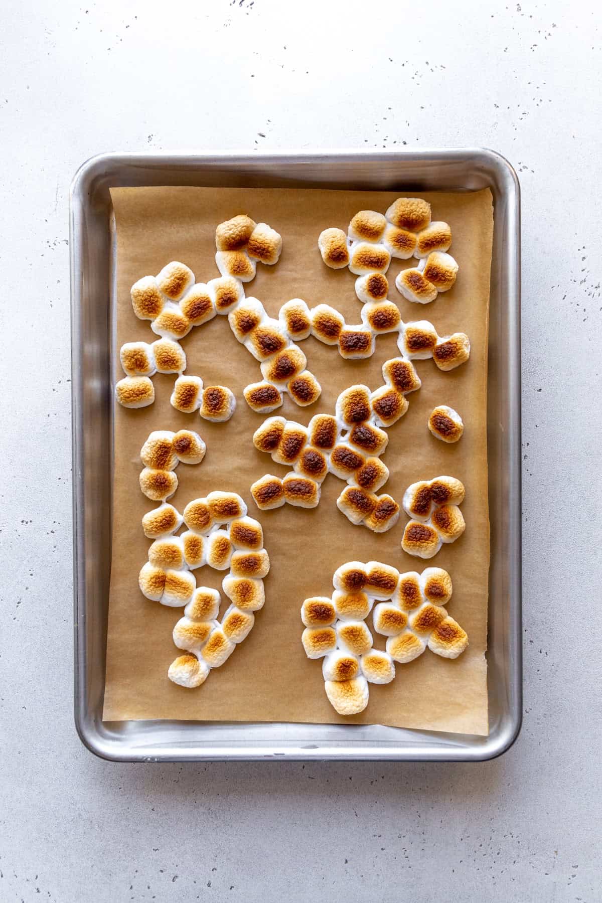 Toasted marshmallows on a baking sheet.