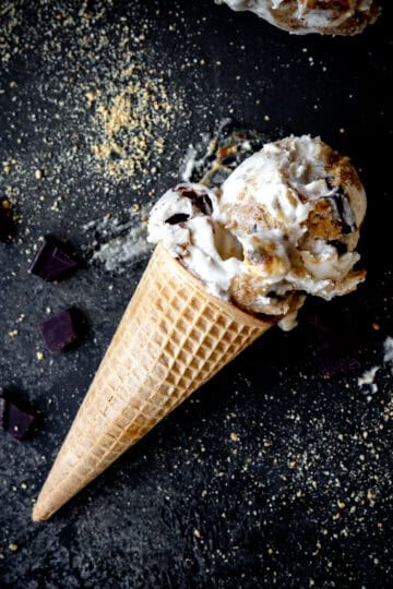 Sugar cone with s'mores ice cream on a black background.
