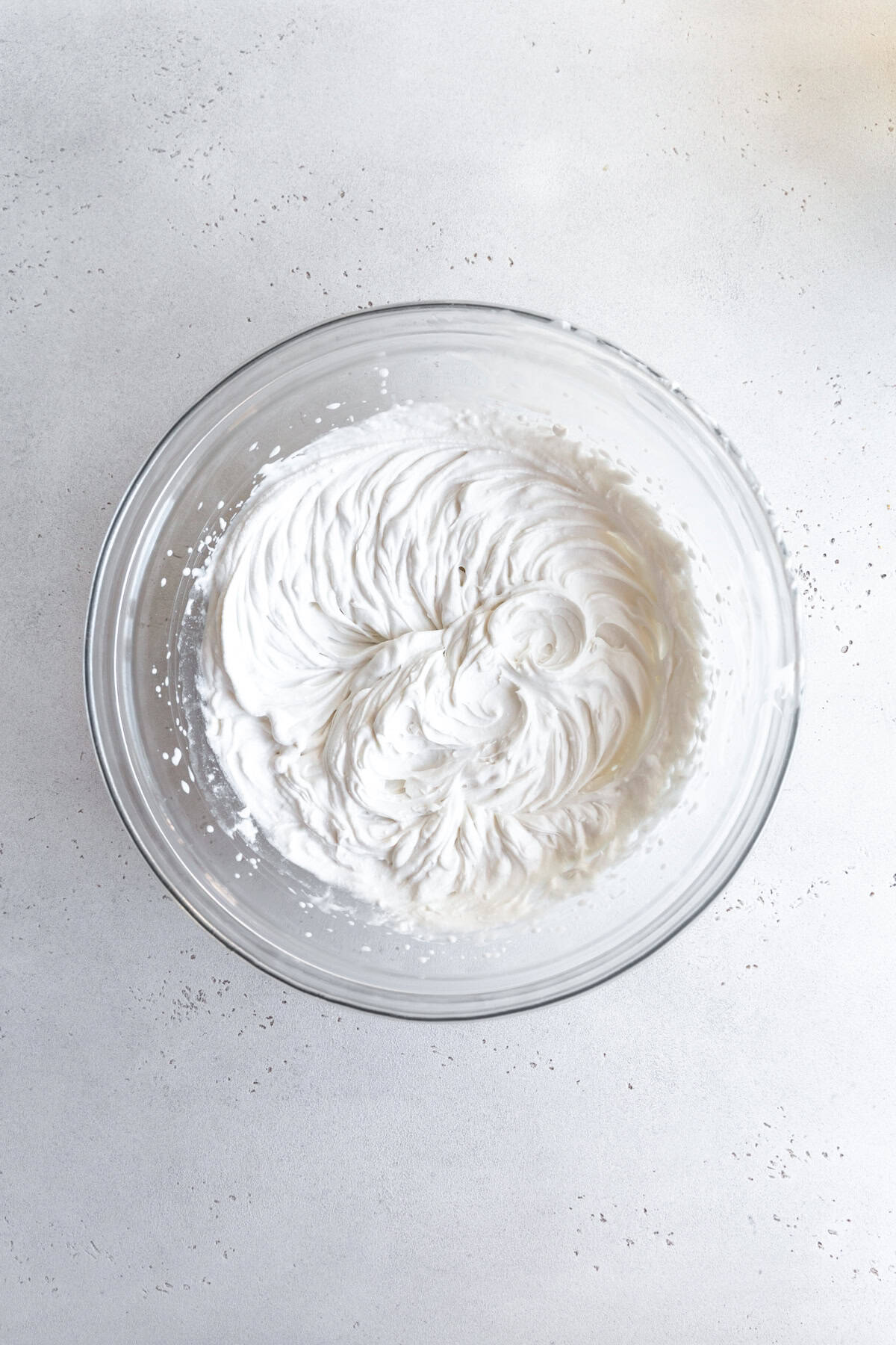 Whipped cream in a glass bowl.