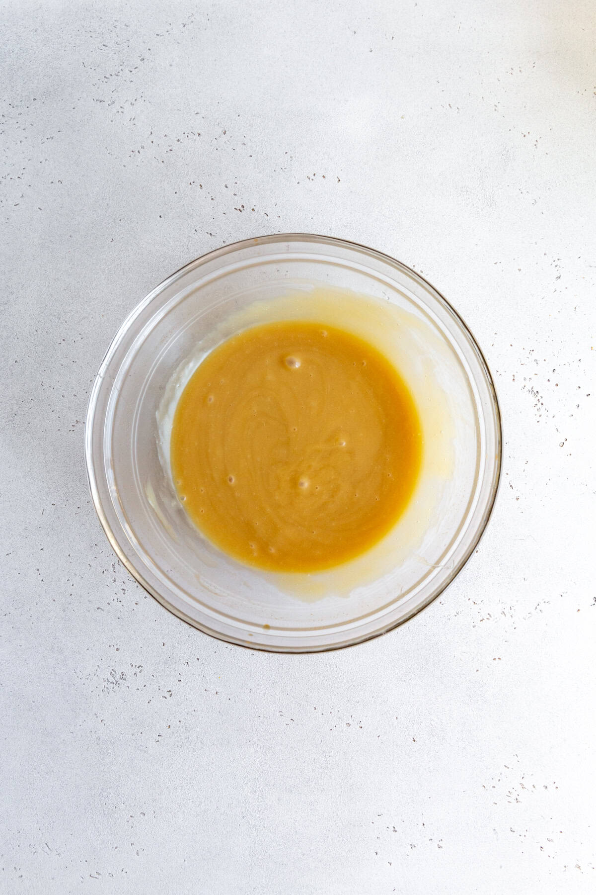 Dairy-free sweetened-condensed milk in a glass bowl.