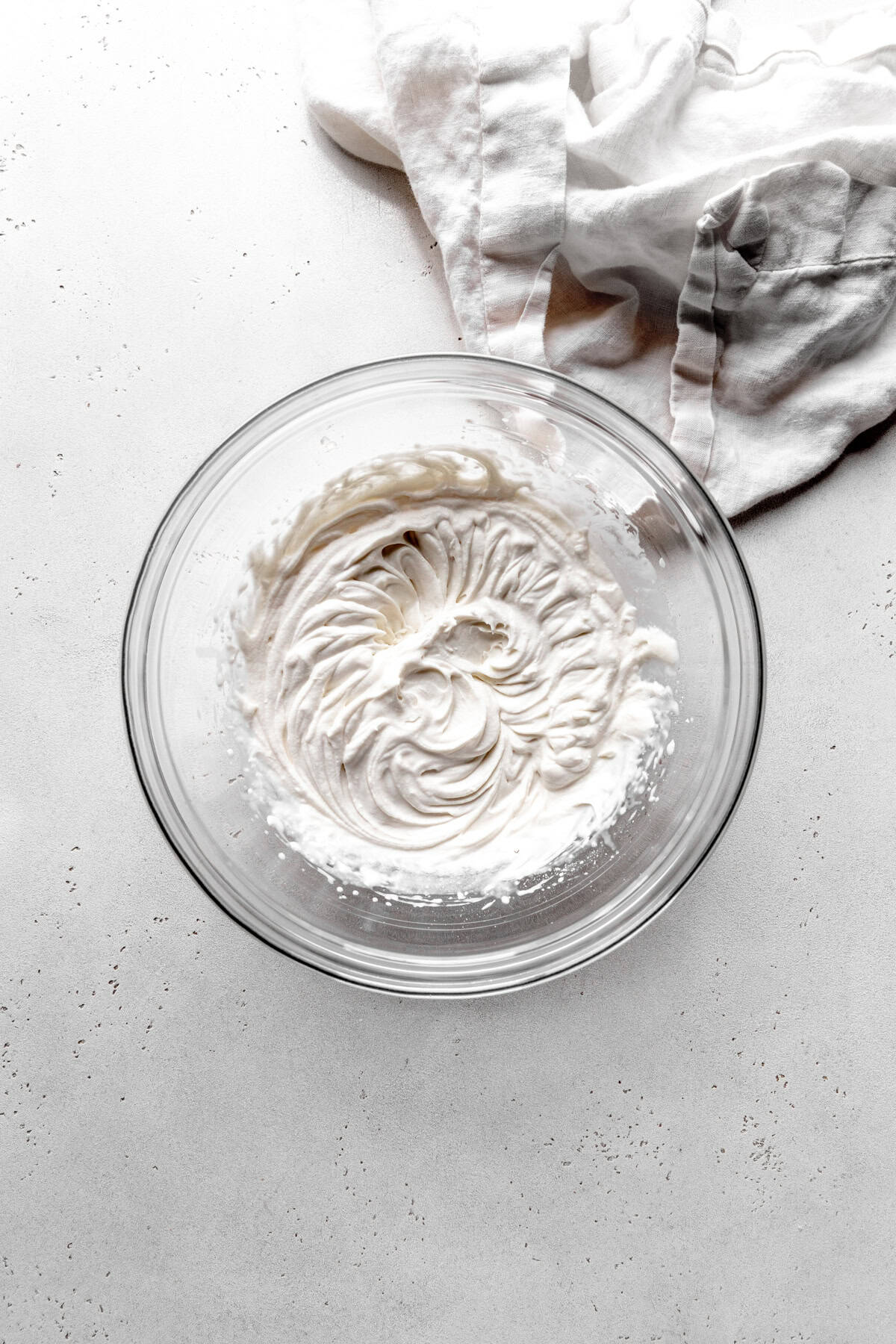 Glass bowl of whipped cream.