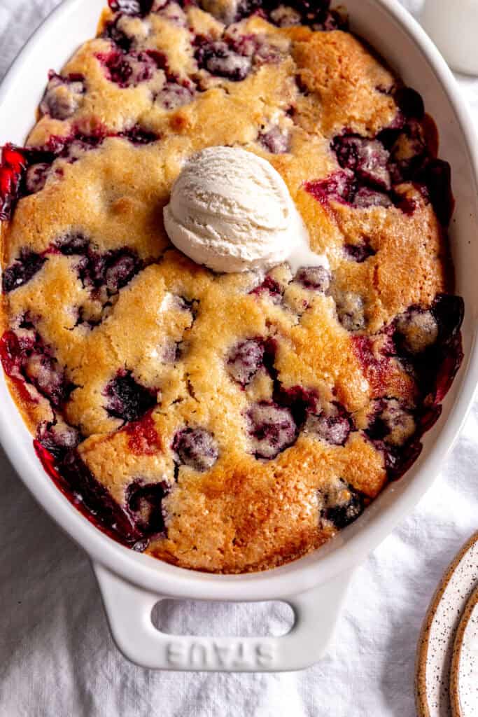 Blackberry cobbler topped with a scoop of vanilla ice cream.