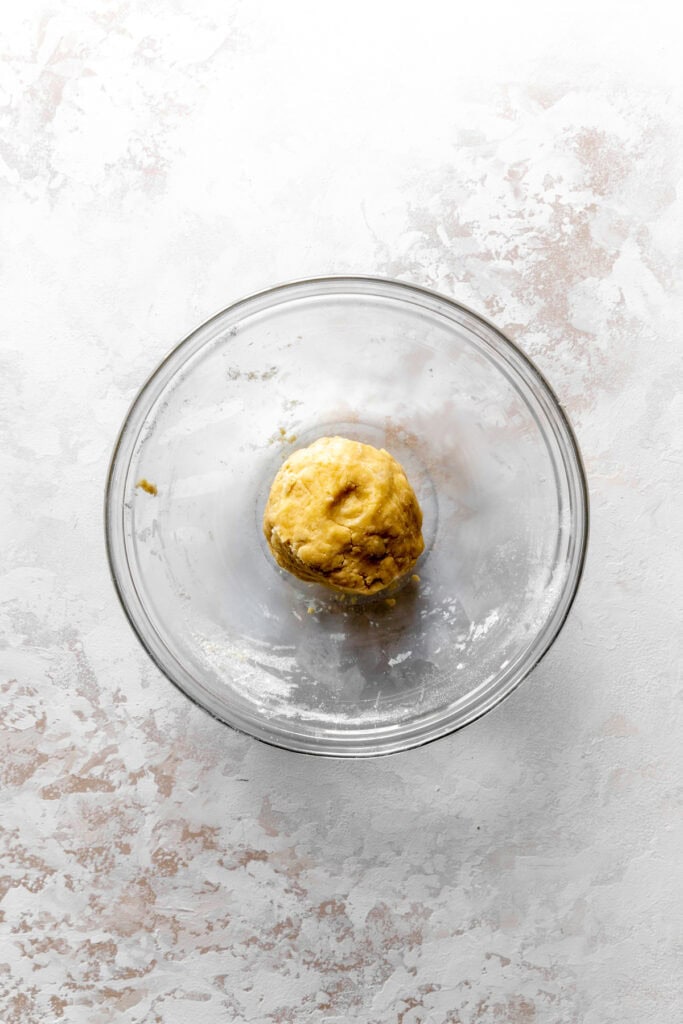 Glass bowl of piecrust dough.