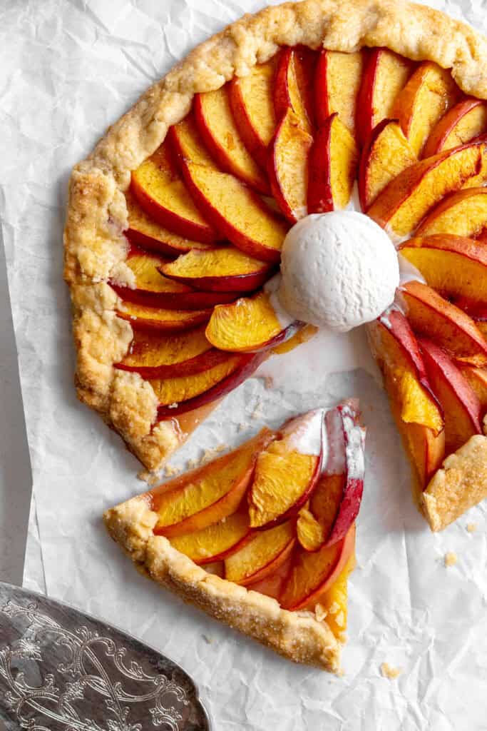 Slice of nectarine galette being pulled out with a spatula.
