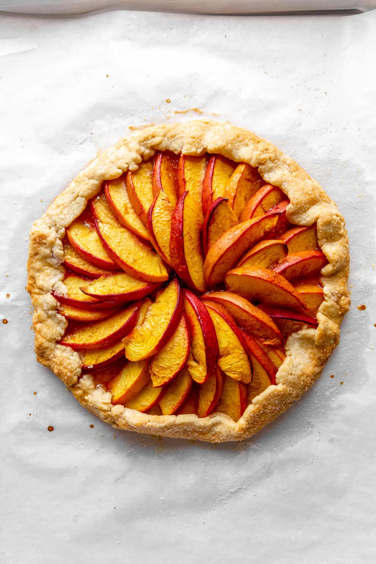 Baked nectarine galette on a baking sheet.