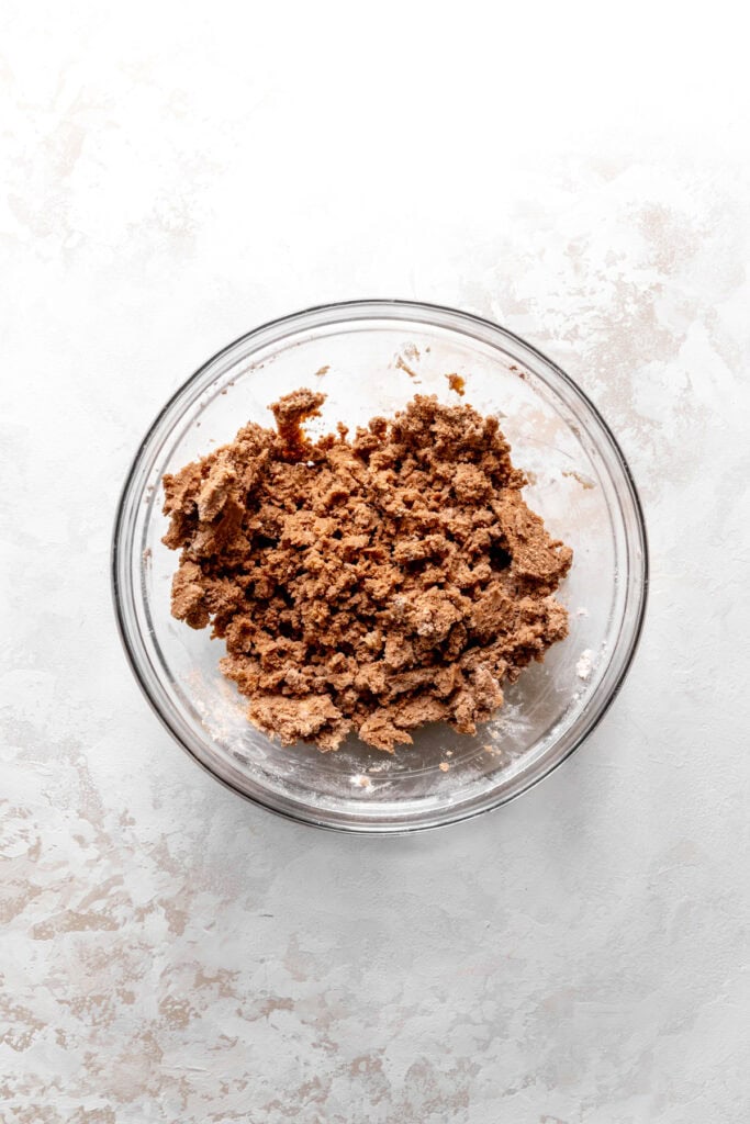 Glass bowl of flour, cocoa powder, and butter.