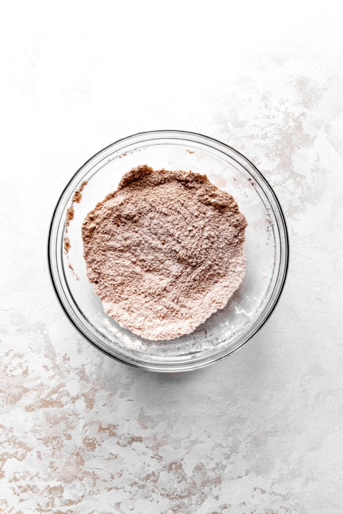 Glass bowl of flour and cocoa powder.